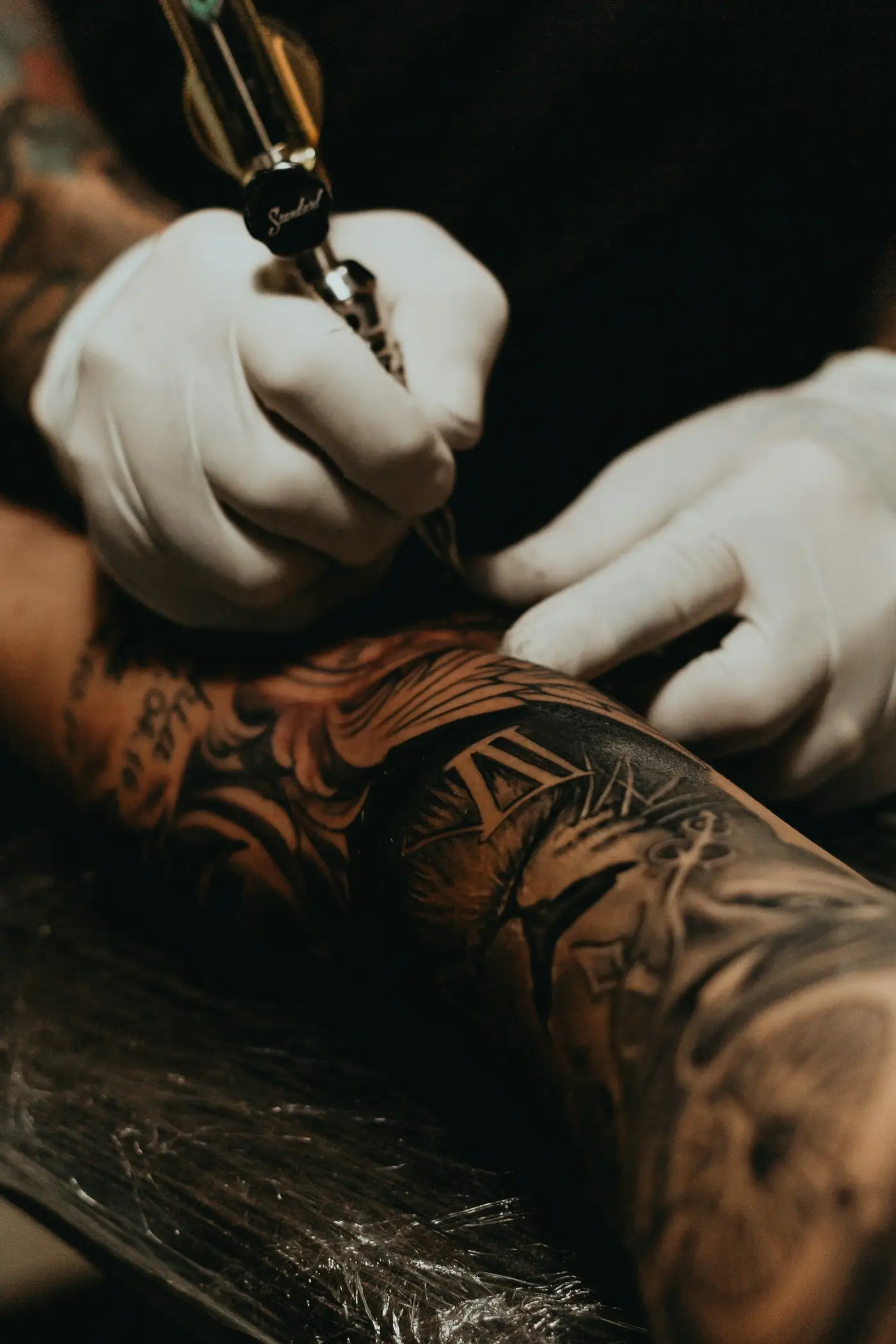Tattoo artist at work in a professional studio
